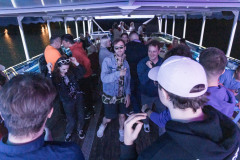 Grupa osób tańczy na pokładzie statku.