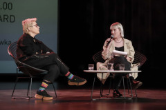 Maria Peszek i Marta Duszyńska siedzą w fotelach na scenie.