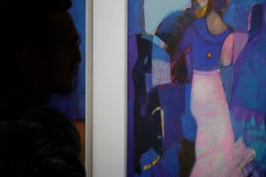 Po lewej ciemny profil mężczyzny. Po prawej jedna z prac utrzmana w niebieskiej tonacji. Przedstawia sylwetki kobiet.